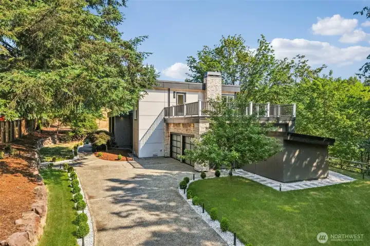 A private setting with a sweeping driveway, mature landscaping and ample guest parking.