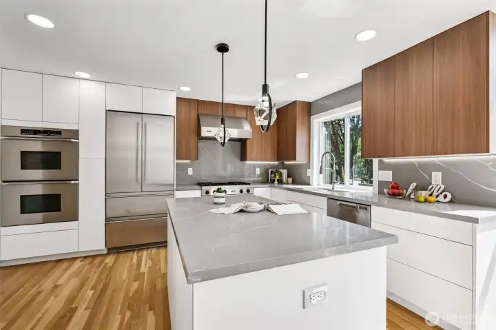 The remodeled kitchen features sleek cabinetry, a spacious island and premium appliances.