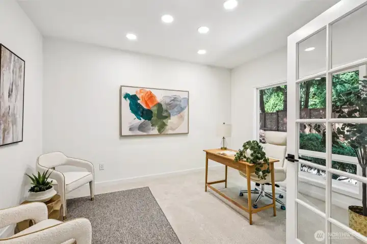 The spacious main-floor office includes room for a desk, seating area and additional furnishings.