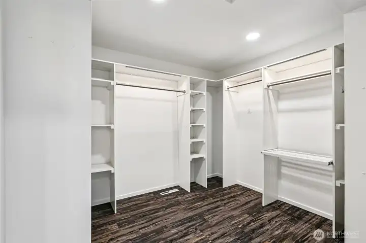 The massive primary walk-in closet offers extensive hanging space, shelving and storage.