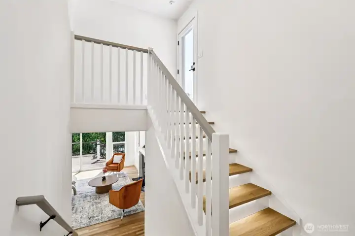 Illuminated stair treads add a stylish architectural detail between the home’s living levels.