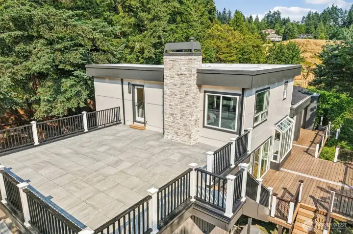 An aerial view showcases the terrace and extensive multi-level deck system.
