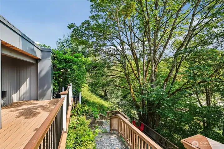 Multiple deck levels connect the home to its private wooded setting and hillside patio.