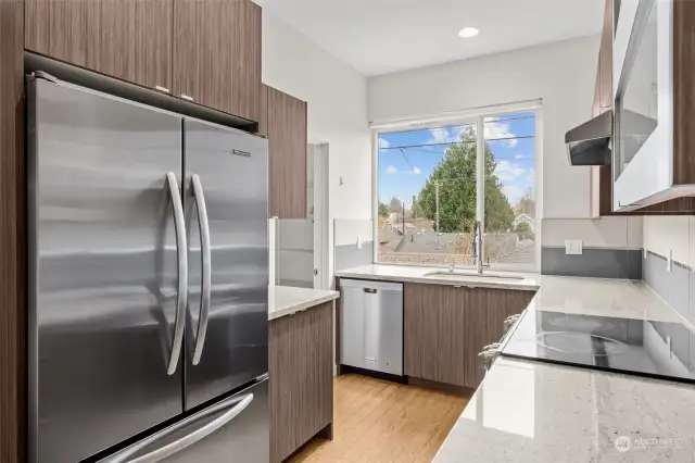 Stainless Steel Appliances & cabinets with slide outs adorn the efficient kitchen.