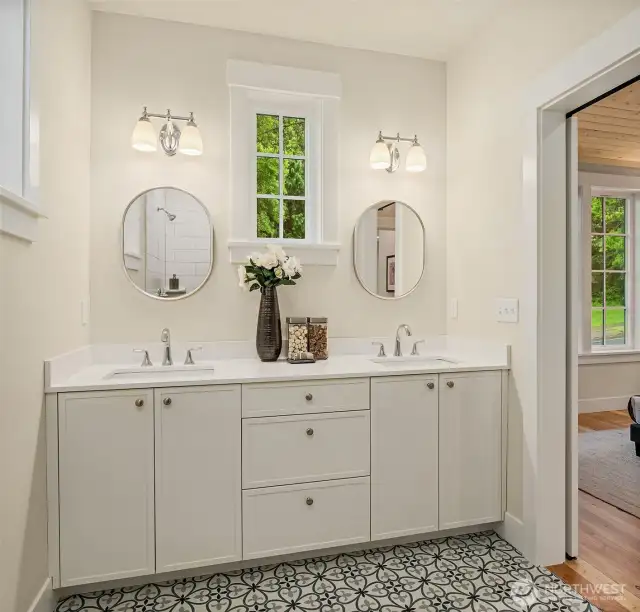 The generous primary bath includes double sinks and is filled with light from the south facing windows.