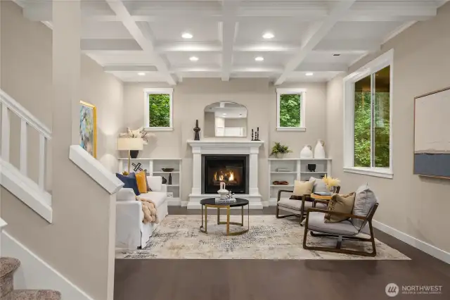 The living room is absolutely beautiful with coffered ceilings, built-in shelves and plenty of windows.