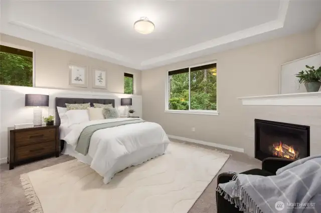 The primary suite includes a fireplace and views of the backyard, woodlands and the Ferry Dell Trail.
