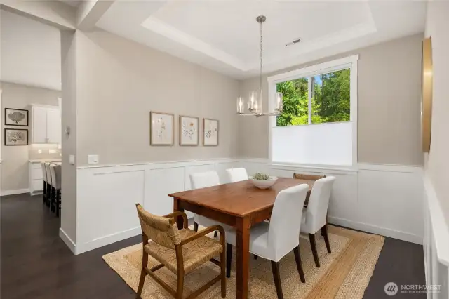 The dining room is open yet separated from the kitchen so everyone can focus on their dinner companions rather than any mess in the kitchen.