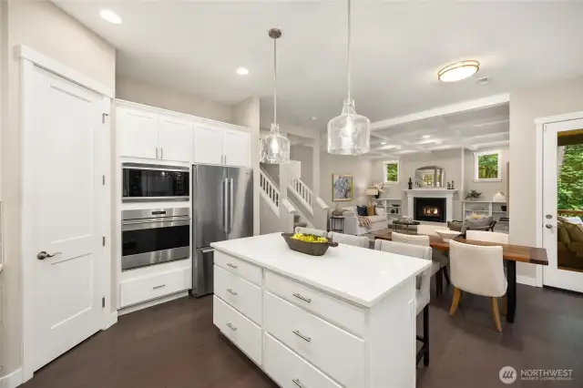 To the left is a walk-in pantry. Wolf wall oven and microwave and large refrigerator. The island provides plenty of storage.