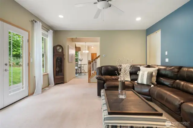 Stylish new exterior door leading out onto patio and fully fenced back yard.