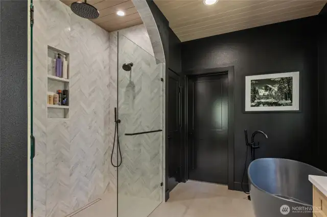 Custom Tile Shower with Rain head and soaking tub that leads to a nice walk in closet.