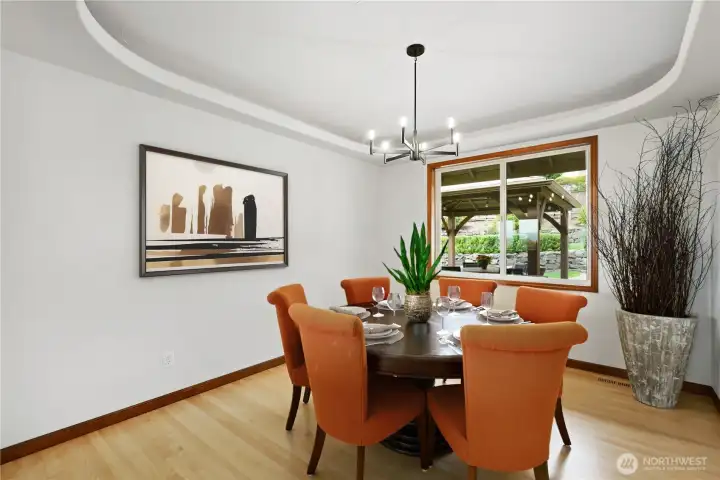 Formal dining room with newly refinished hardwood floors and views of the back yard.  Portions of this photo are virtually staged.