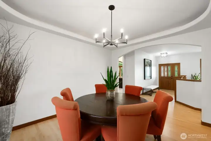 Formal dining room with inset ceiling lighting, opens to entry and kitchen.