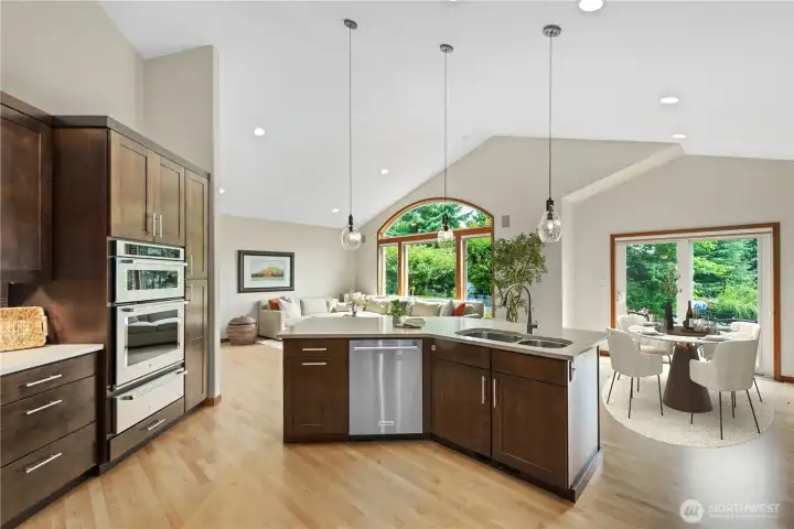 Open floor plan from the kitchen to the family room and the casual eating nook.  Dining table is virtually staged.