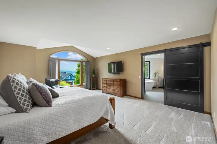 Primary Suite with barn door to the bathroom.