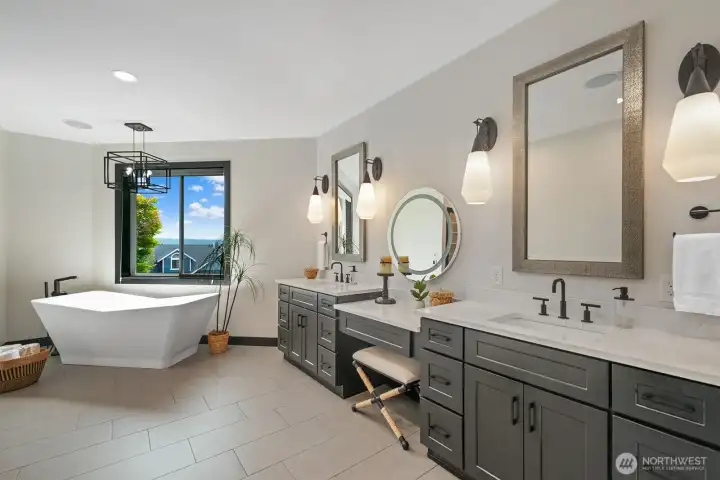 Luxurious remodeled Primary Bathroom with heated floors and free standing soaking tub.