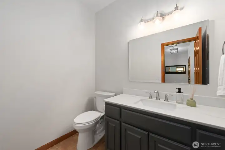 Powder room near the laundry room, garage and back yard.