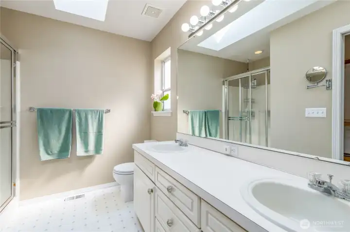 Primary bathroom includes double sinks and walk-in closet