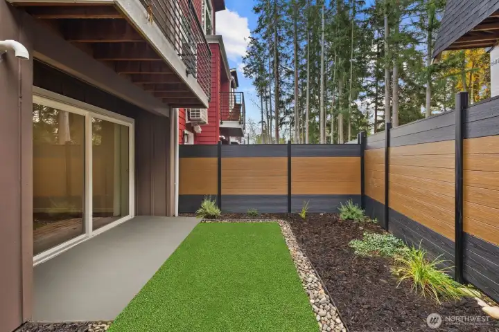 Private, fully fenced yard with easy care turf.