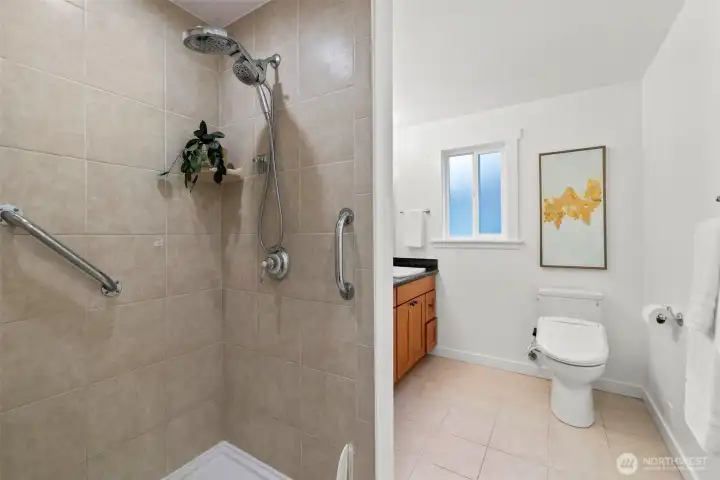 The generous Primary bath features tile floors and a tiled walk-in shower