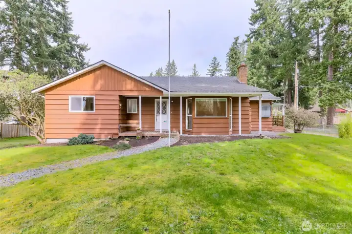 Gated entrance and walkway welcome guests from the half circular driveway that provides off street parking. Love the addition of the flag pole!