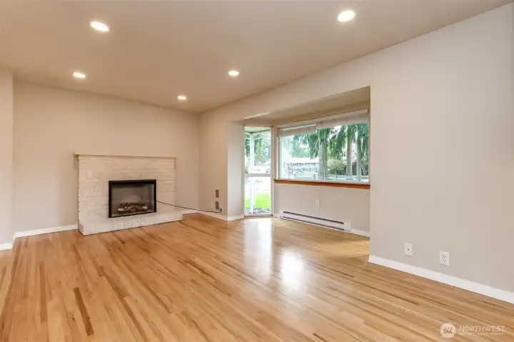 Gorgeous refinished hardwood floors and electric fireplace insert warms and invites you into the living space.