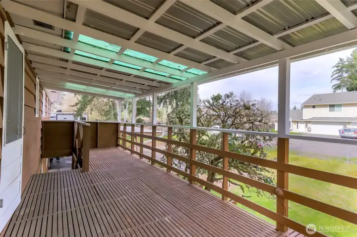 Another view of the deck and stairs coming up to deck and kitchen from the carport and backyard.