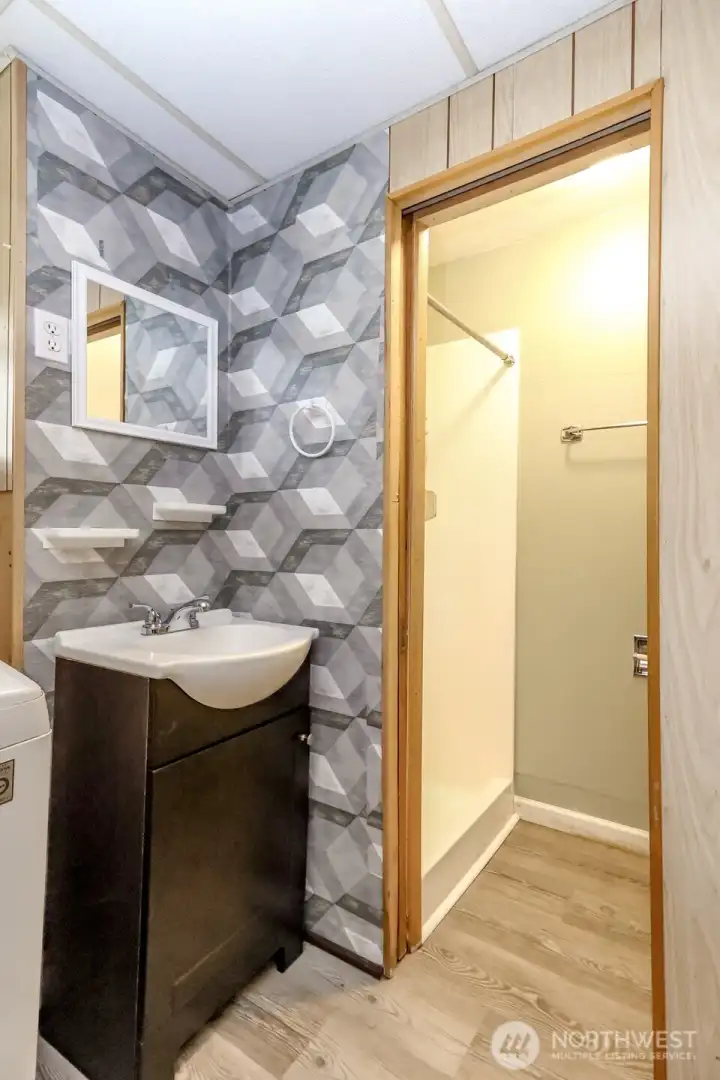Downstairs bath with private step-in shower and toilet room.