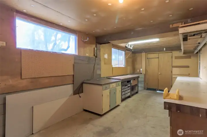 Separate entrance from under the carport leads you into this great shop with work benches and separate storage room too! Big windows give you extra light!