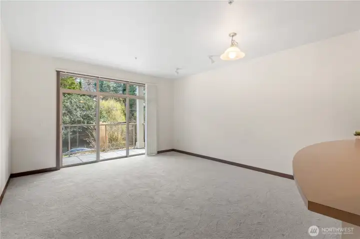 Large windows and sliding glass door go out to private patio