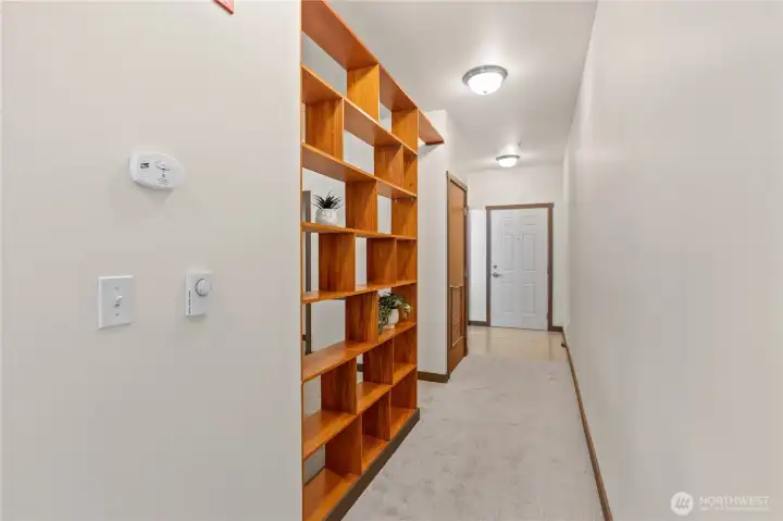 Hallway, view toward front door. On left are bedroom area, laundry/utility closet and bathroom