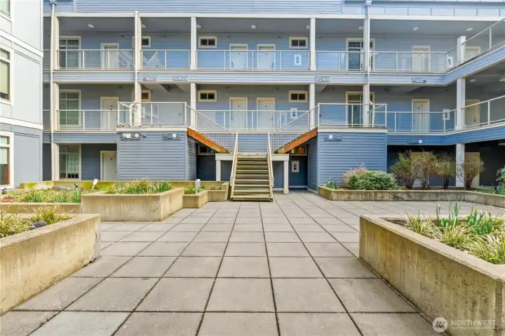 Sunny and open courtyard leads directly to unit