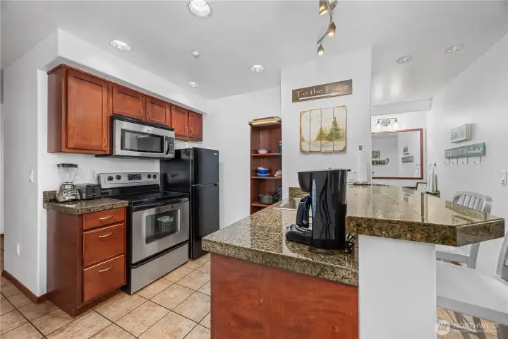Fully-equipped kitchen includes an oven, microwave, and dishwasher.