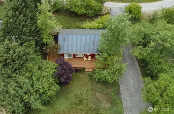 Aerial view showing the expanded deck overlooking private backyard.