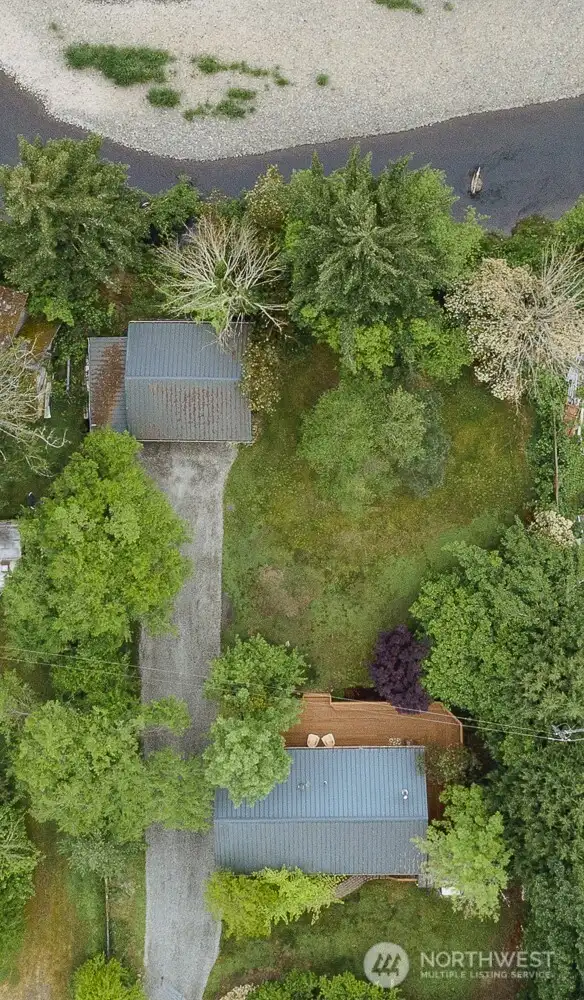 Aerial view showing the home, garage, and the high bank of the Descutes River.