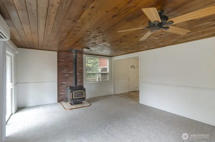 This view shows the front door access and kitchen is around the corner.