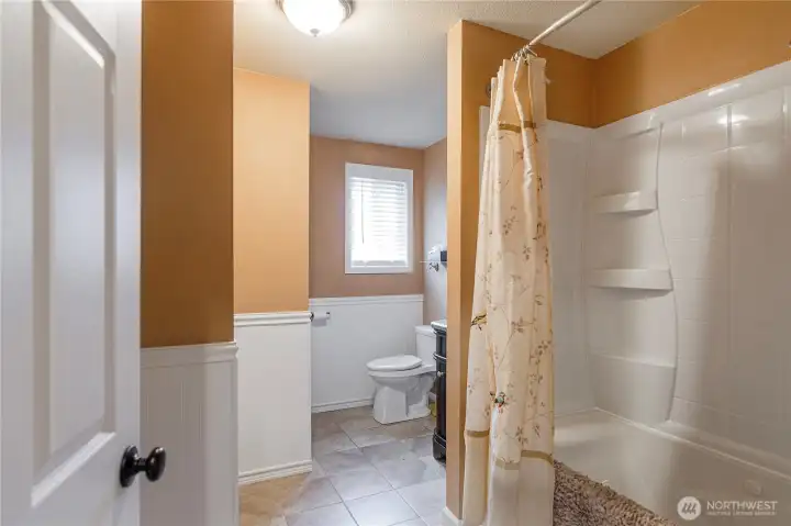 Updated full bath with heated jetted tub, tiled floors and updated vanity.