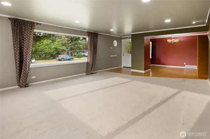 The inviting living room welcomes you in, with the dining area creating a natural extension of the living space.