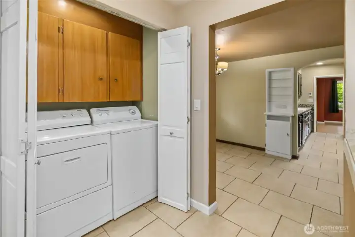 Dedicated laundry space featuring additional storage for everyday essentials.