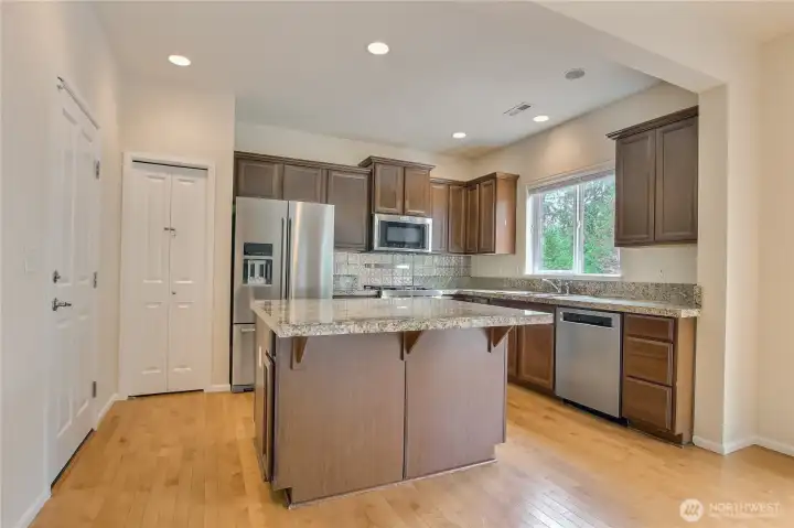 Granite countertop, island, and pantry. Garage entrance to the left. Granite countertop, island, and pantry. Garage entrance to the left.