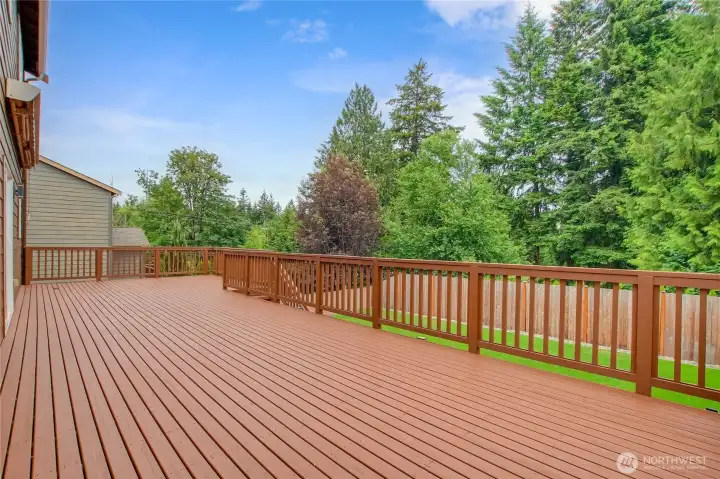 Expansive back deck off of the main level sliding doors. Stairs leading to lower level covered concrete patio and grass area. Expansive back deck off of the main level sliding doors. Stairs leading to lower level covered concrete patio and grass area.