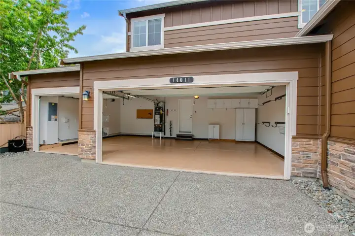 Spacious 3 car garage with storage cabinets and expoxy floor. Spacious 3 car garage with storage cabinets and expoxy floor.