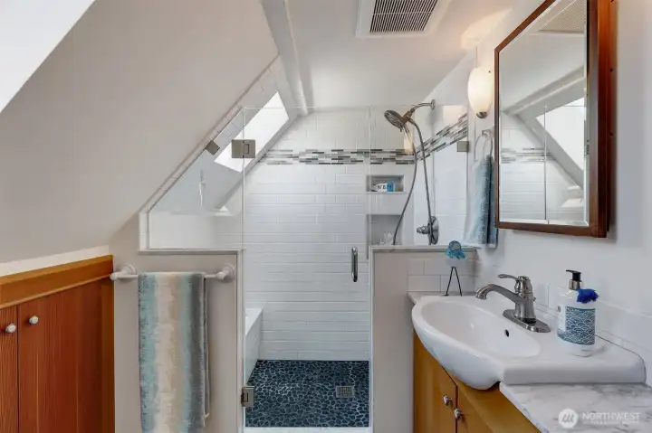 The cabinet in the left of this photo is HUGE with SO MUCH STORAGE.  We particularly love the window inside the shower for natural light.