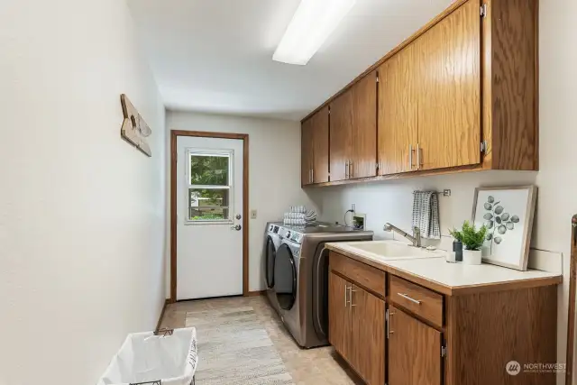 Stainless washer and dryer on the upper level.