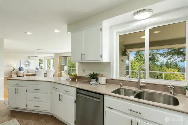 Kitchen features new lighting, new appliances and cabinet pulls.