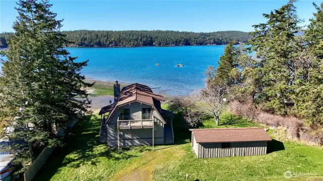 Street view of house and garage with Shoal Bay in background