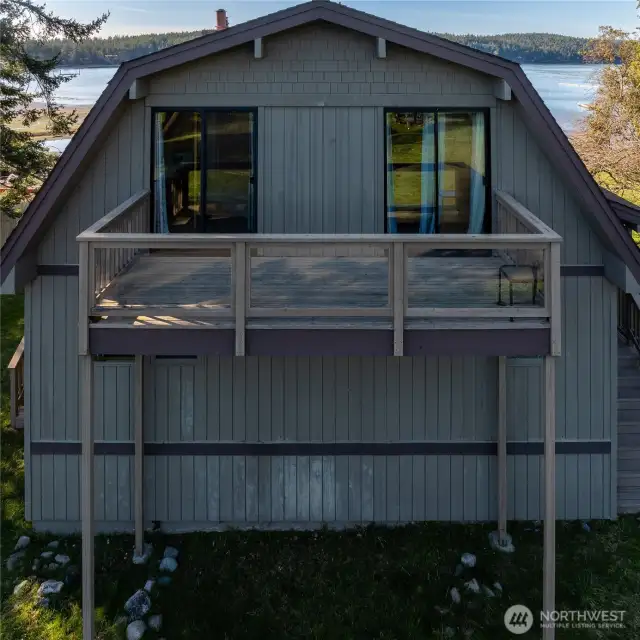 Streetside view of home. Shoal Bay in background; upper deck looks toward Swifts Bay