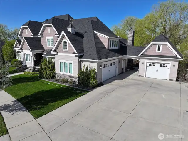 Double Car Attached Garage & Single Car Detached.  Driveway transforms into a Pickleball court