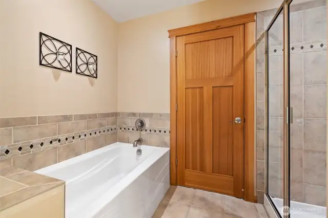 Soaking tub and walk-in shower in primary bath.