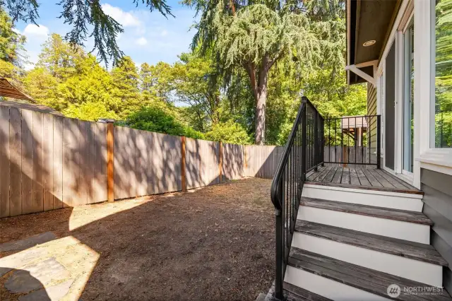 The fully fenced backyard provides privacy and space for kids, pets, and a BBQ grill.